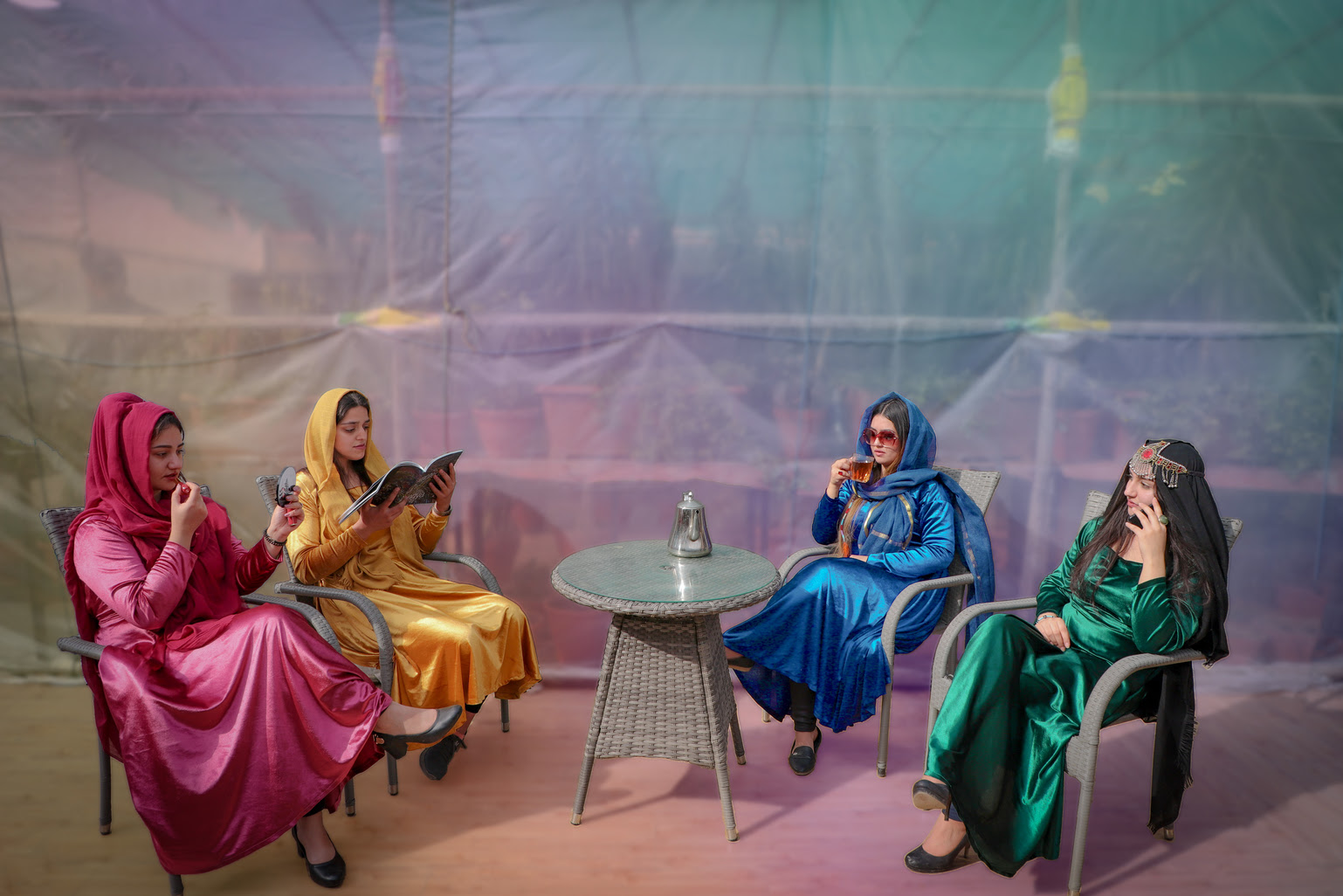 quatre femmes en afghanistan portent des robes et sont assises