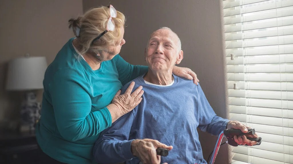 Older adult smiling at a caregiver