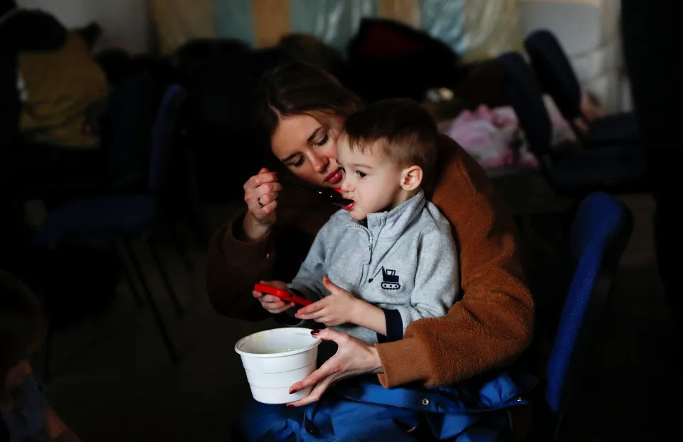 A mother feeds her child at a refugee shelter in Hungary.