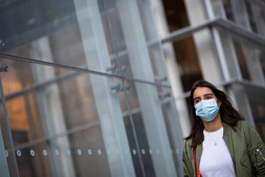 A woman wears a face mask as she walks in Manhattan, New York.