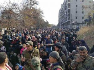 People gather to leave Al-Salhen neighborhood in eastern Aleppo on Dec 8, 2016 (European Pressphoto Agency-EPA)