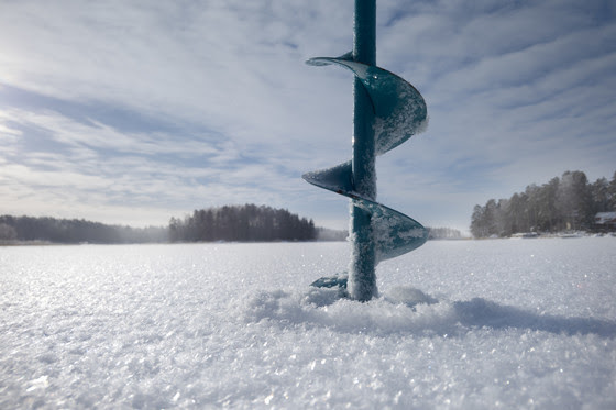 ice auger drilling through ice