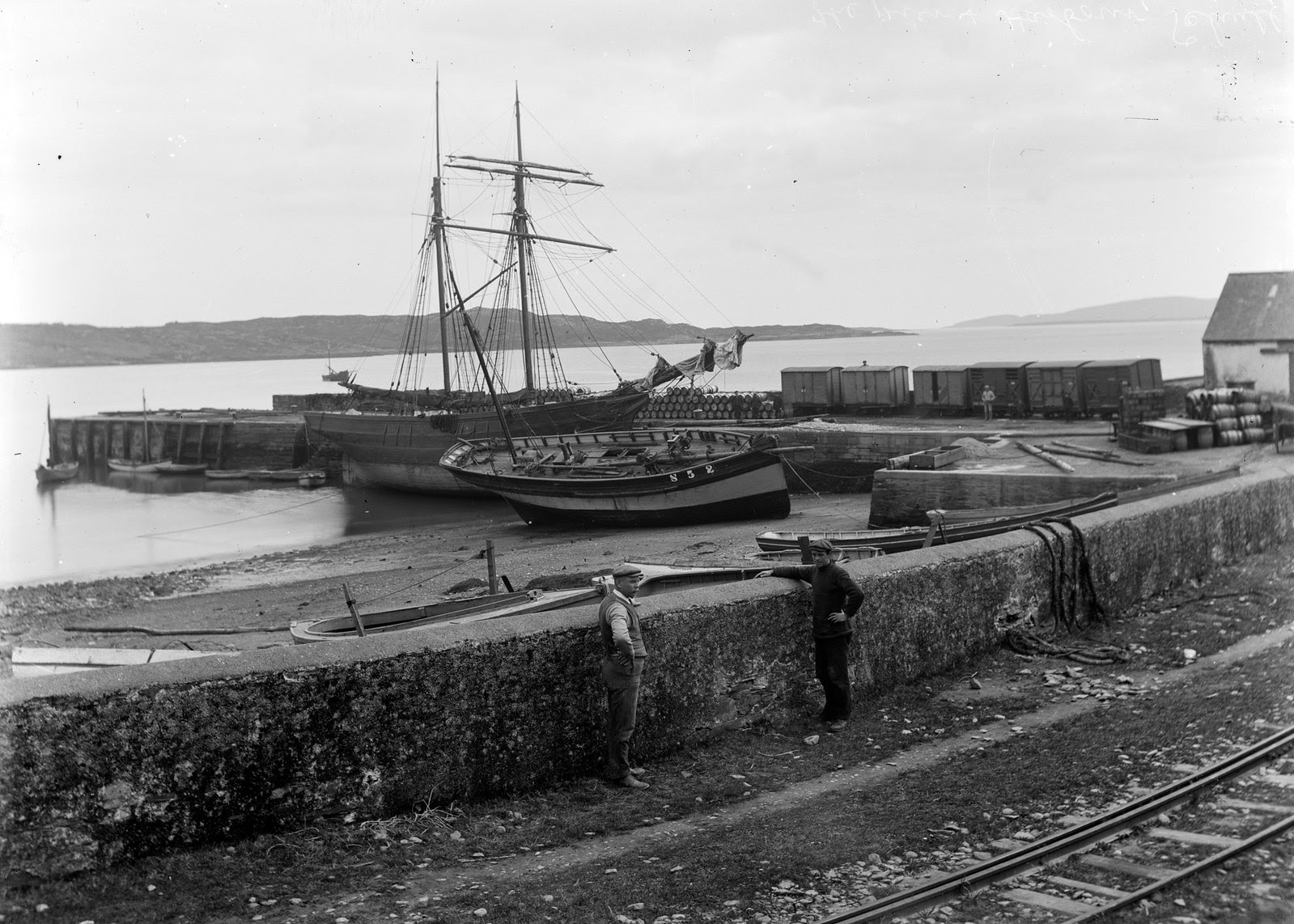 Boats moored by a harbour, in an unknown location (probably Schull, Co Cork) | by National Library of Ireland on The Commons
