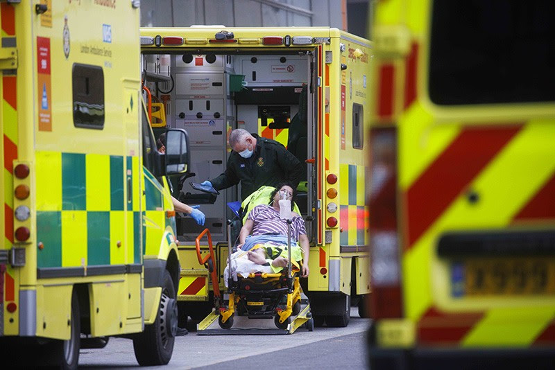 Patients with the Omicron variant of Covid-19 are moved by ambulance from overfilled NHS hospitals in London, UK.