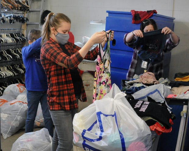 Students sorting through donated clothing