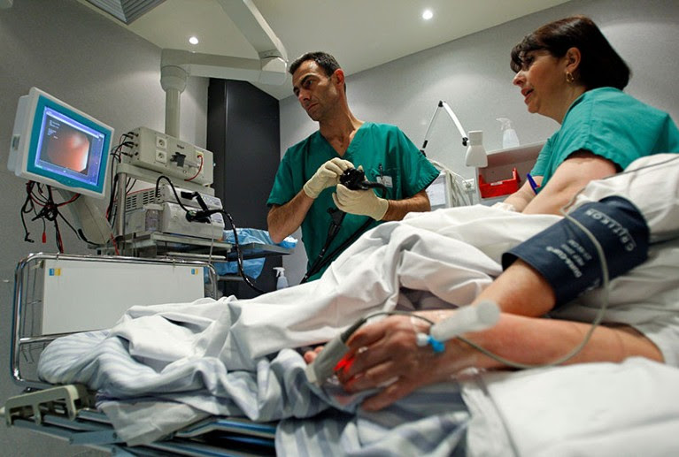 A French doctor performs a colonoscopy on a patient at the Ambroise Pare hospital in Marseille.