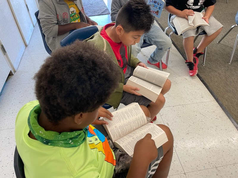 Boys reading bibles in group
