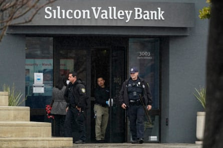 Santa Clara Police officers exit Silicon Valley Bank in Santa Clara, California.