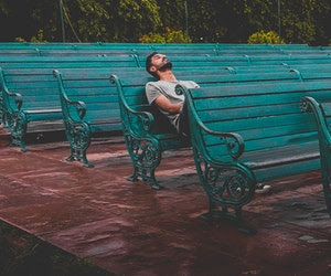 man sitting alone on bench