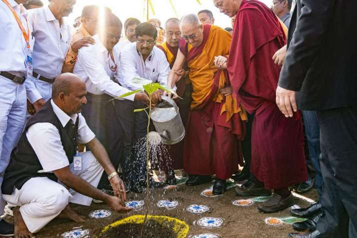 His Holiness the Dalai Lama waters a sapling in Maharashtra, India. Photo by Tenzin Choejor. From dalailama.com