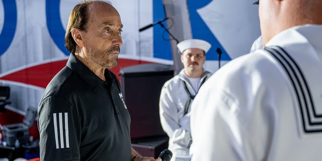 Lee Greenwood takes time to talk with members of the U.S. Navy during a visit to "Fox and Friends" at the Fox News Channel studios on May 27, 2022, in New York City.