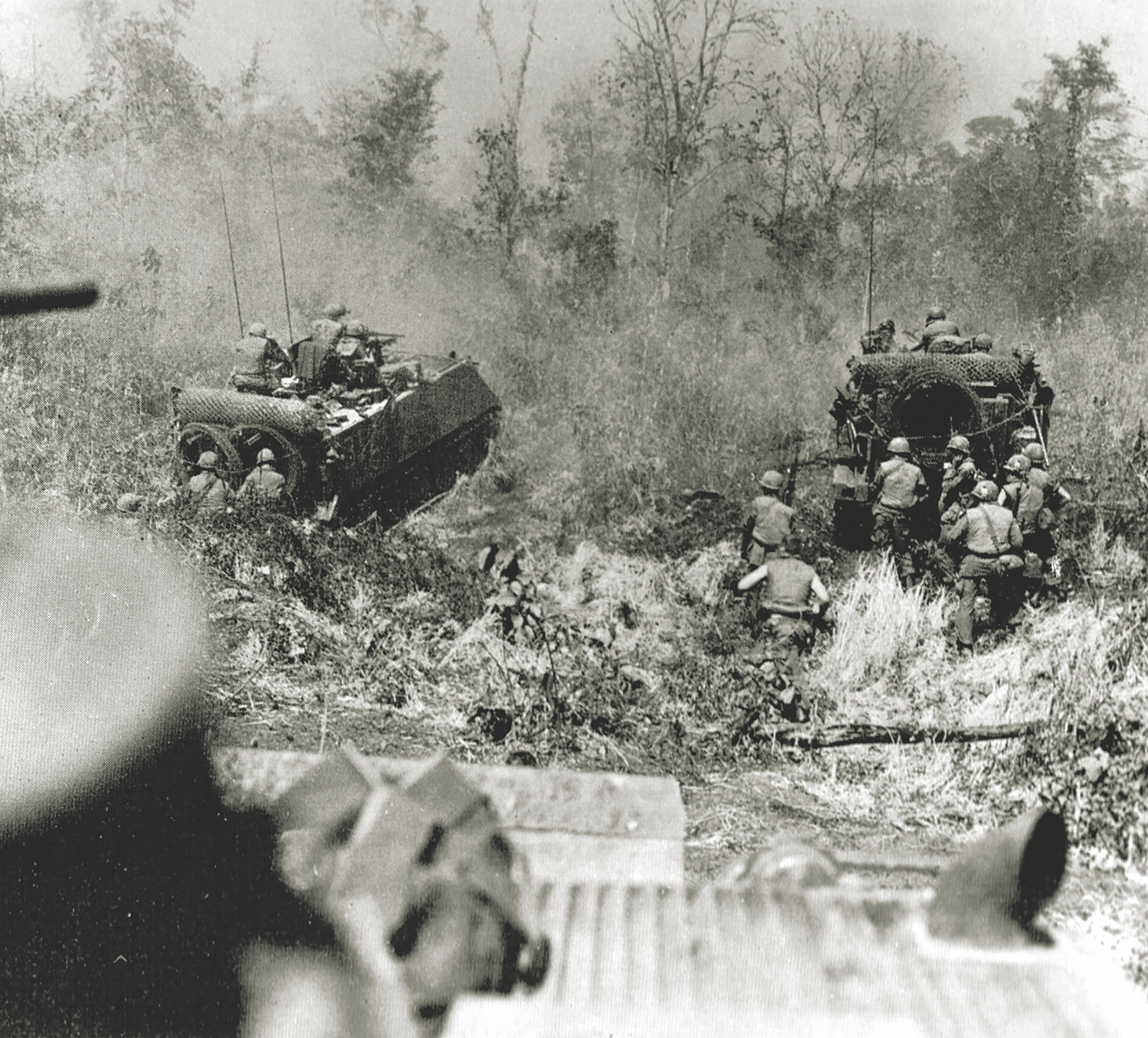 M113 Infantry teams advance into the bush. The personnel carriers often lined up side by side as they went into battle. (PJF Military Collection/Alamy)