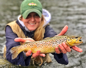 Woman angler with brown trout