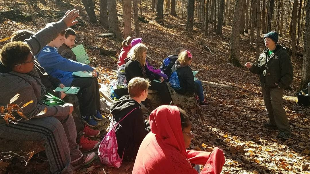 A station facilitator teaching children during Leonard Springs Nature Days