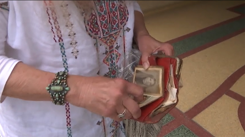 A woman looking through an old wallet