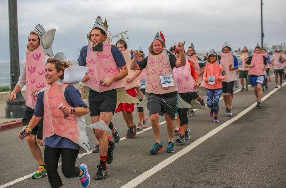 Racers dressed as salmon running upstream at a past Redondo Beach Super Bowl 10k