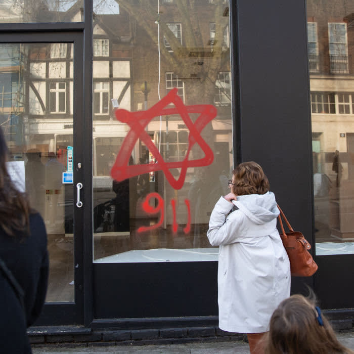 Anti-semitic graffiti in the form of numbers, 9 11, and a Star of David, on a shop window in Belsize Park, North London. credit PA Images