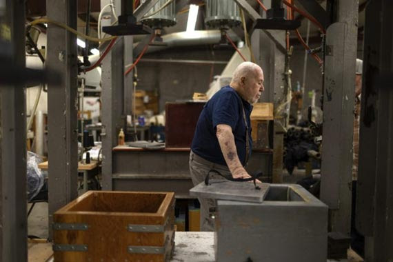 Jerry Wigutow walking past machines in his factory Jerry Wigutow walking past machines in his factory