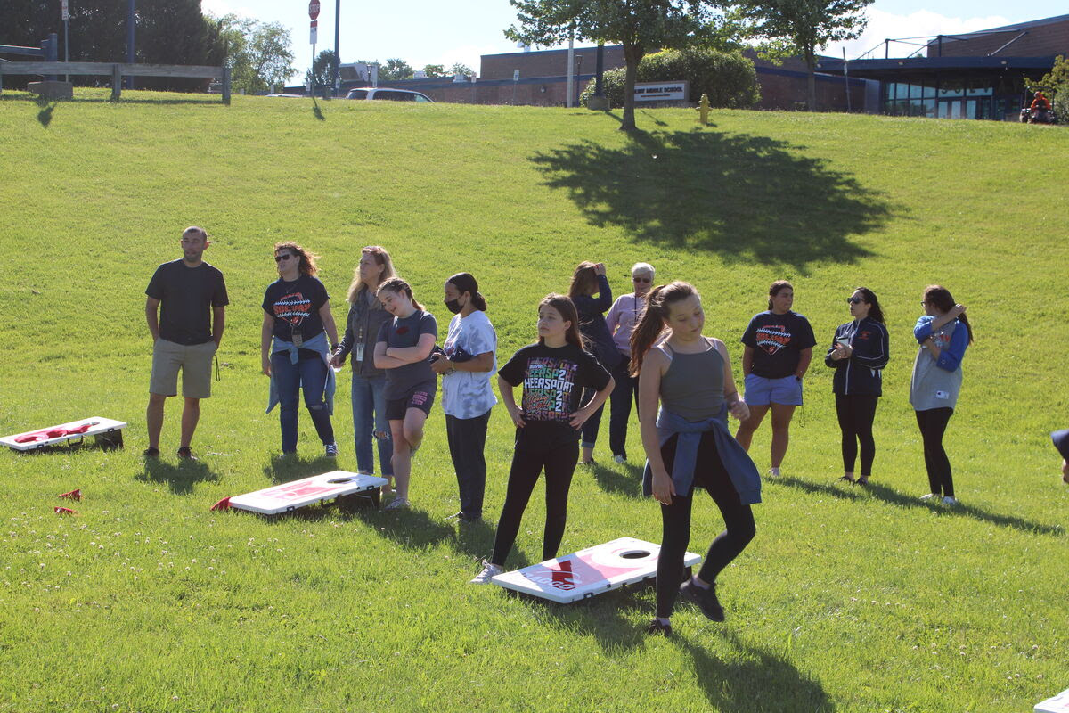 students play field day games outdoors on grass