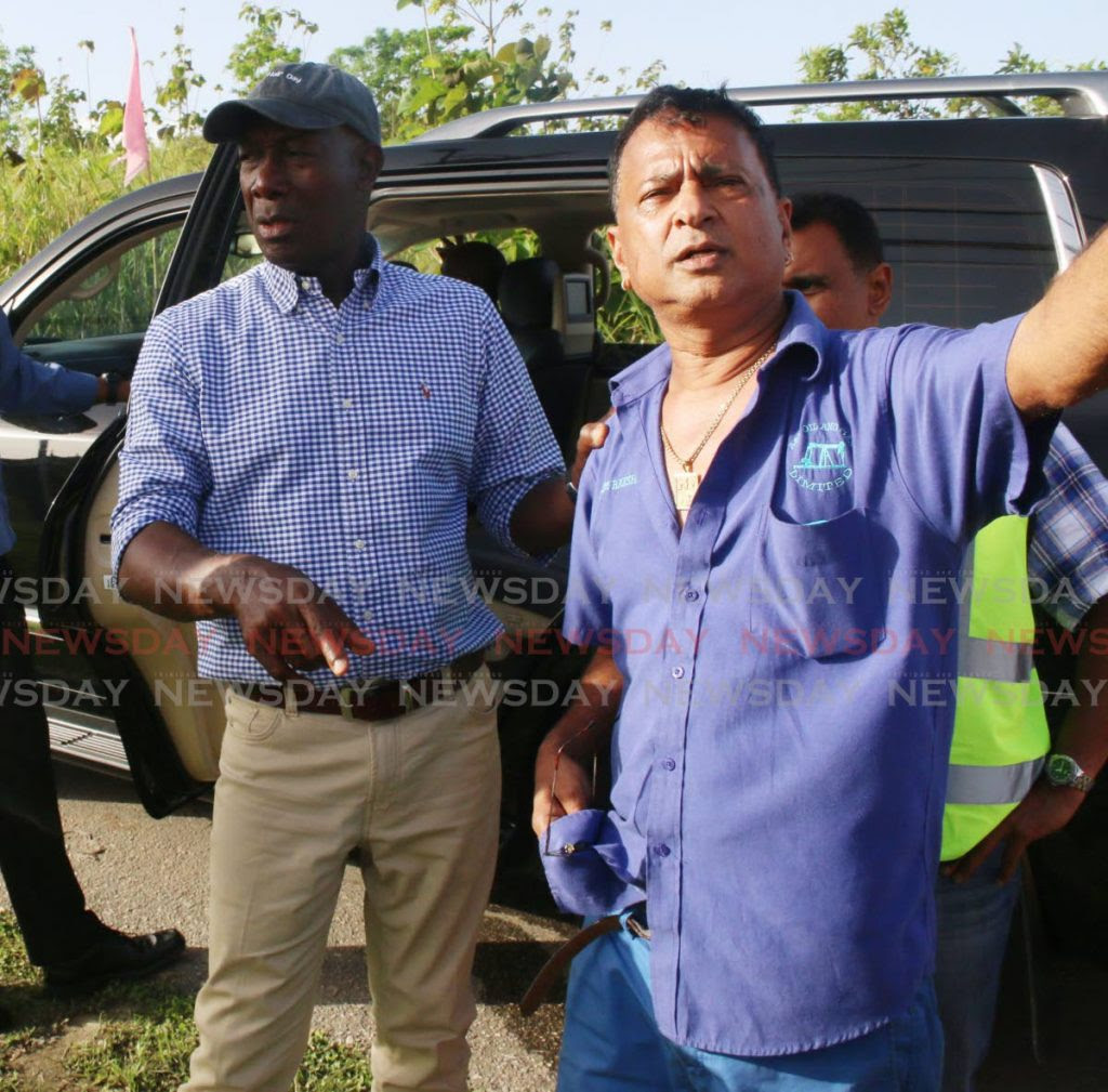 In this 2017 file photo, A&V Oil owner Nazim Baksh, right, with Prime Minister Dr Keith Rowley during a tour of flood affected areas in Penal. -