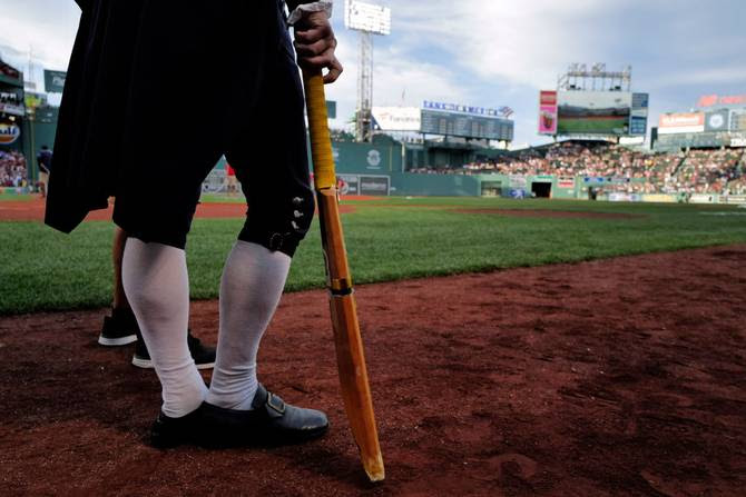 Guy with a cricket bat at Fenway Park