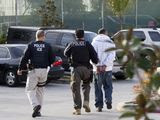 In this March 30, 2012, file photo, Immigration and Customs Enforcement (ICE) agents take a suspect into custody as part of a nationwide immigration sweep in Chula Vista, Calif. (AP Photo/Gregory Bull) ** FILE **