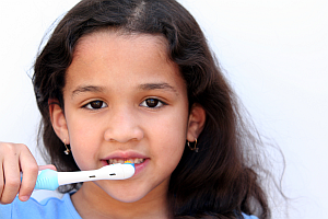 photo of a girl brushing her teeth