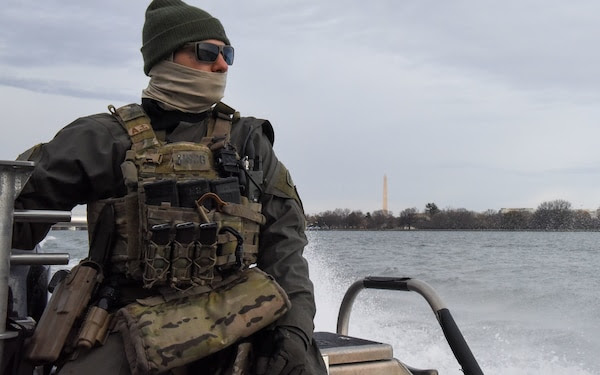  A crewmember from Maritime Security Response Team-East, located in Chesapeake, Va., looks on during a security patrol on the Potomac River in Washington ahead of the 2021 Presidential Inauguration, Jan. 16, 2021. On Sept. 24, 2018, the Department of Homeland Security designated the Presidential Inauguration as a recurring National Special Security Event. Events may be designated NSSEs when they warrant the full protection, incident management and counterterrorism capabilities of the Federal Government. (U.S. Coast Guard photo by Petty Officer 3rd Class Kimberly Reaves/Released) 