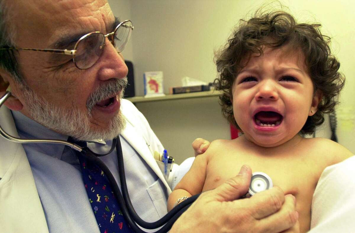 Dr Fernando A. Guerra examines 18-month-old Alicia Vallejo in 2000, at his office on West Commerce.