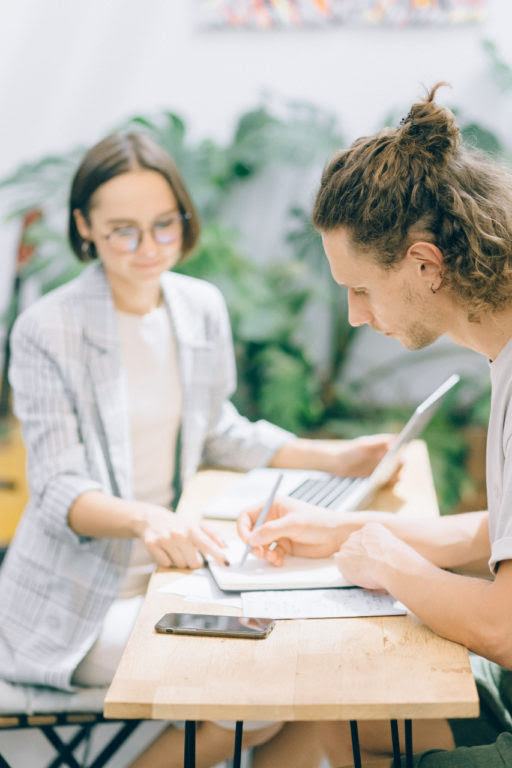 Integrator sitting at a table with the Visionary, walking them through a business process.