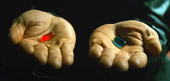 red and blue pills in hands