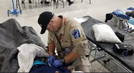 Photo of DMAT personnel caring for Hurricane Florence patient in shelter