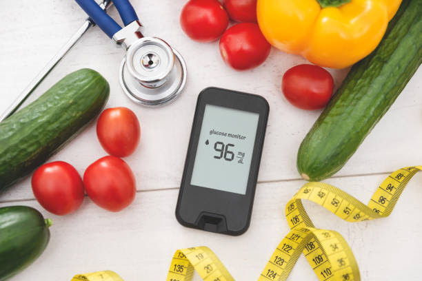 Glucometer with fresh vegetables. Diabetes concept Glucometer with fresh vegetables. Healthy food, diet and nutrition control blood sugar levels stock pictures, royalty-free photos & images