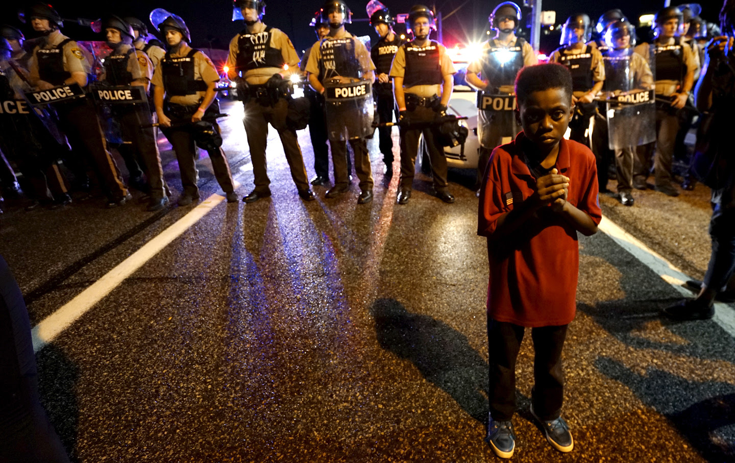 Child stands in front of police