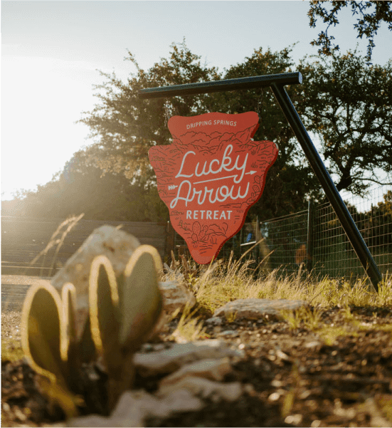 Lucky Arrow retreat sign in front of a setting sun