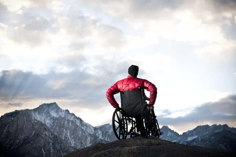 A man in a wheelchair looking to the heavens