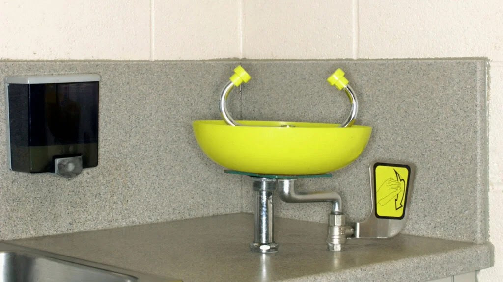 An image of an eye washing station in a lab, that a person can use to clean their eyes.