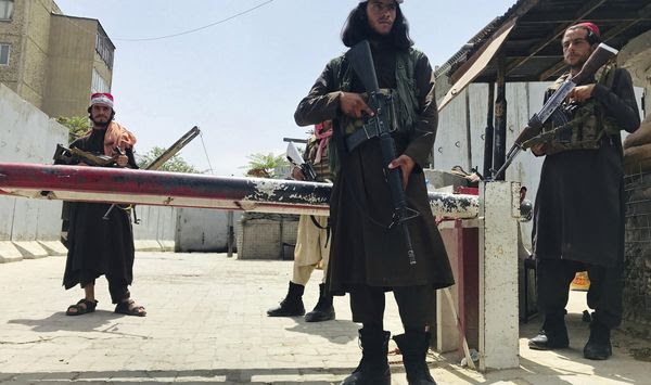 Taliban fighters stand guard at a checkpoint near the US embassy that was previously manned by American troops, in Kabul, Afghanistan, Tuesday, Aug. 17, 2021. The Taliban declared an &amp;quot;amnesty&amp;quot; across Afghanistan and urged women to join their government Tuesday, seeking to convince a wary population that they have changed a day after deadly chaos gripped the main airport as desperate crowds tried to flee the country. (AP Photo)