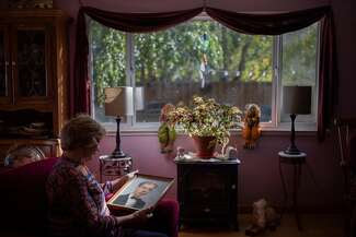 Melissa Honrath holds a framed photograph of her brother, Jae Stevens.