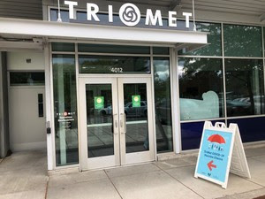 Sandwich board clinic sign in front of TriMet office. 