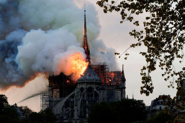 Slide 19 of 31: Flames and smoke are seen billowing from the roof at Notre-Dame Cathedral in Paris on April 15, 2019. - A fire broke out at the landmark Notre-Dame Cathedral in central Paris, potentially involving renovation works being carried out at the site, the fire service said. (Photo by Geoffroy VAN DER HASSELT / AFP) (Photo credit should read GEOFFROY VAN DER HASSELT/AFP/Getty Images)