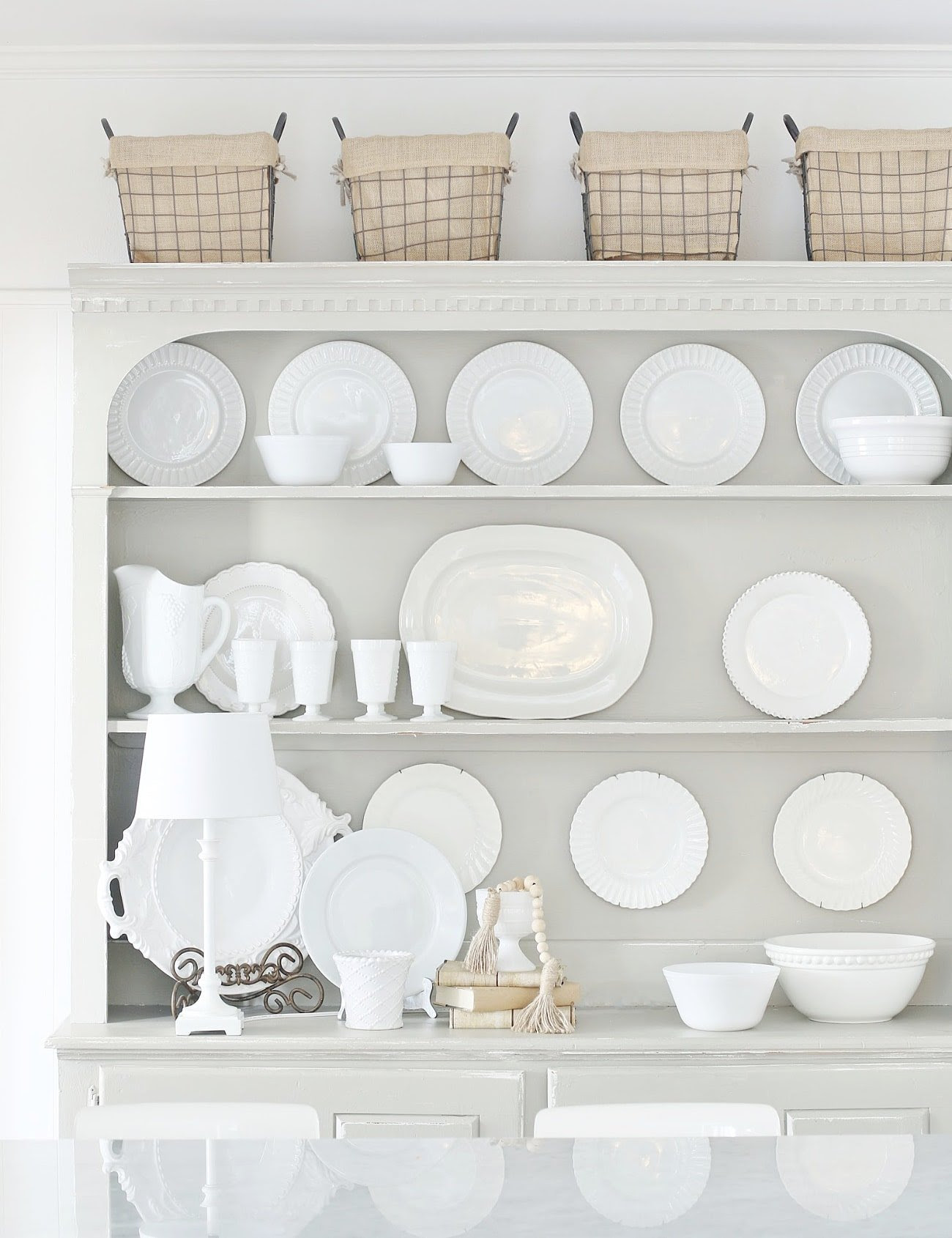 gray kitchen hutch with white dishes and plates