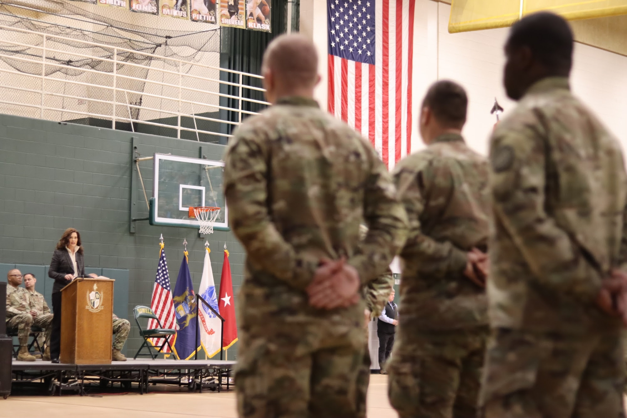 Gov. Whitmer speaks at podium during deployment ceremony at Howell High School