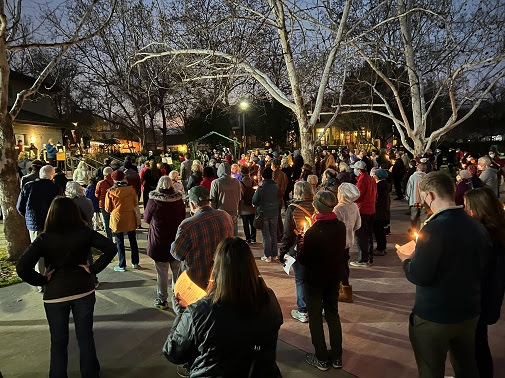 People gather for a candlelight vigil in Davis Central Park on Jan. 6th