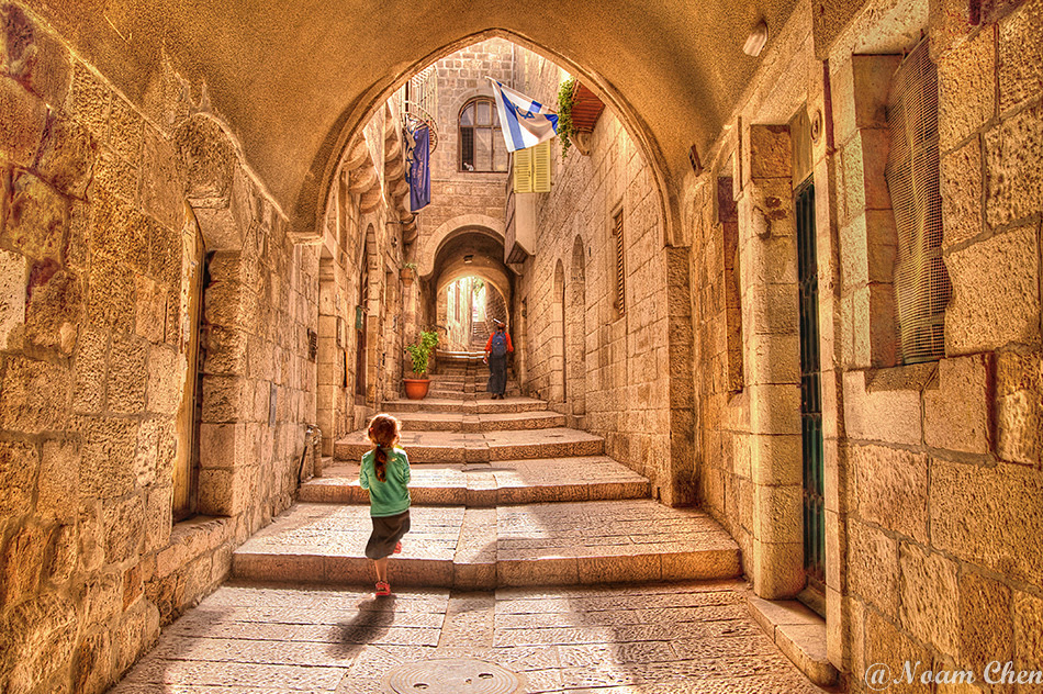 little girl walking up the alleyway at the jewish quarter in jerusalem 