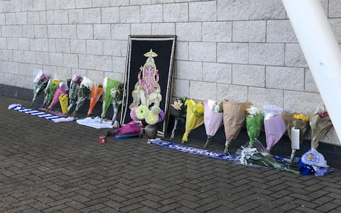 Flowers are laid outside the King Power Stadium on Sunday morning