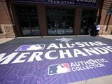 Shoppers head into Diamond Dry Goods, the team store for the Colorado Rockies at Coors Field, past a sidewalk sign advertising All-Star Game merchandise after a news conference Wednesday, July 7, 2021, to kick off All-Star week in Coors Field in Denver. (AP Photo/David Zalubowski) **FILE**