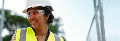 female working in construction wearing safety gear