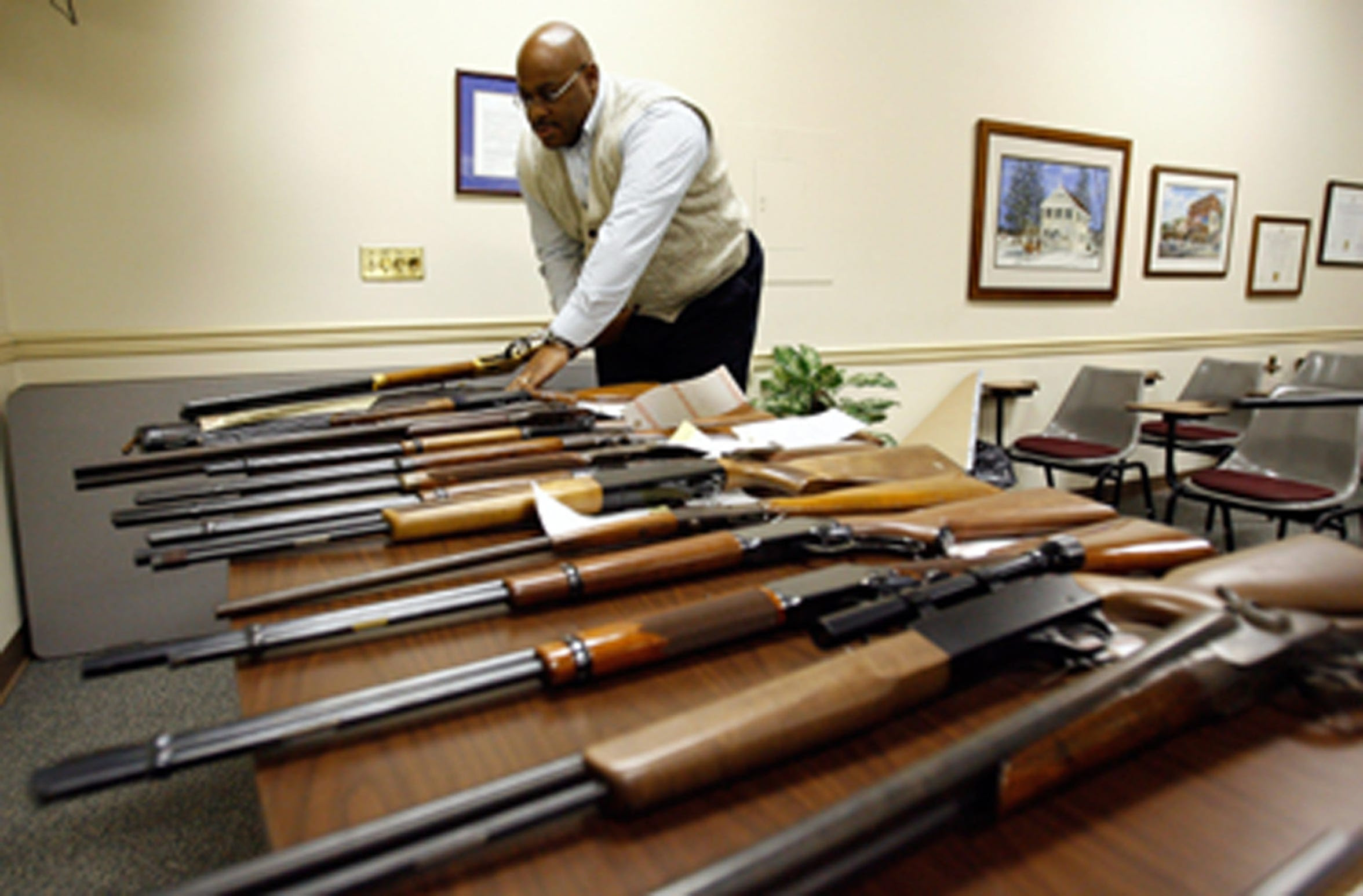 In this photo from The News Journal archives, Quinton Watson, then-commander of Safe Streets and a captain within the department, stands with weapons seized from a man who was charged with weapons and drug offenses as well as violating a Protection from Abuse Order. Watson touched nearly every unit within the department during his career.