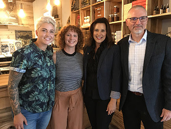 Officials pose for a photo, including Gov. Gretchen Whitmer.